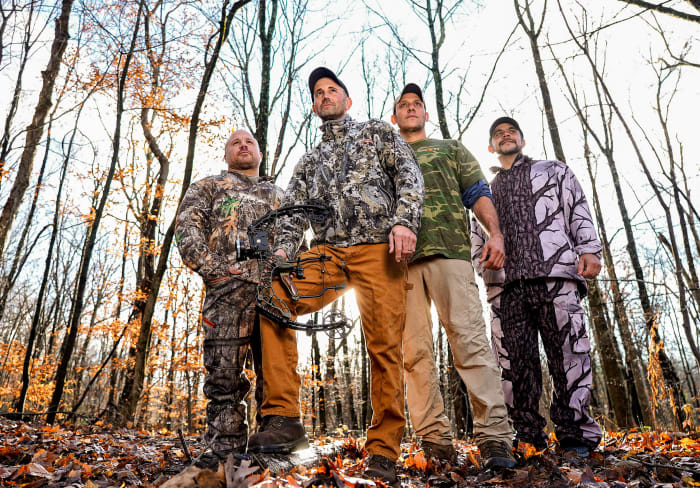 Melillo (holding bow) with Wayne Davis (second from right), who helped track the bear, and hunting buddies Marc Yodice and Jason Famularo.